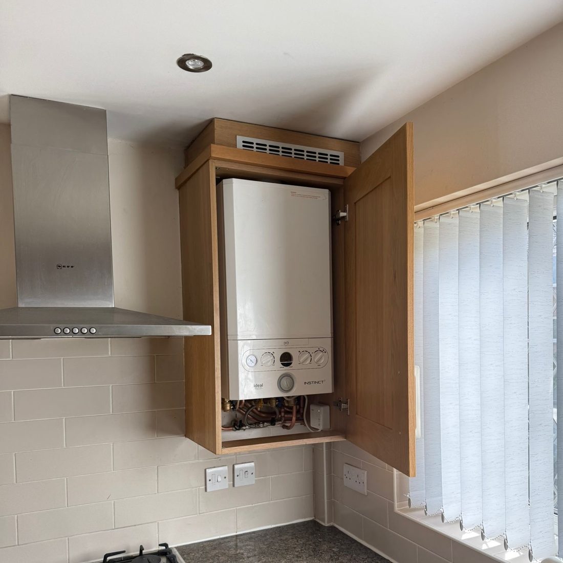 Combi boiler housed neatly inside a kitchen wall unit