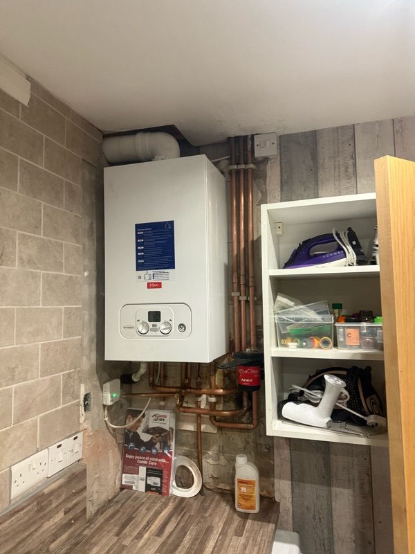 Combi boiler installed in a utility room with new pipework