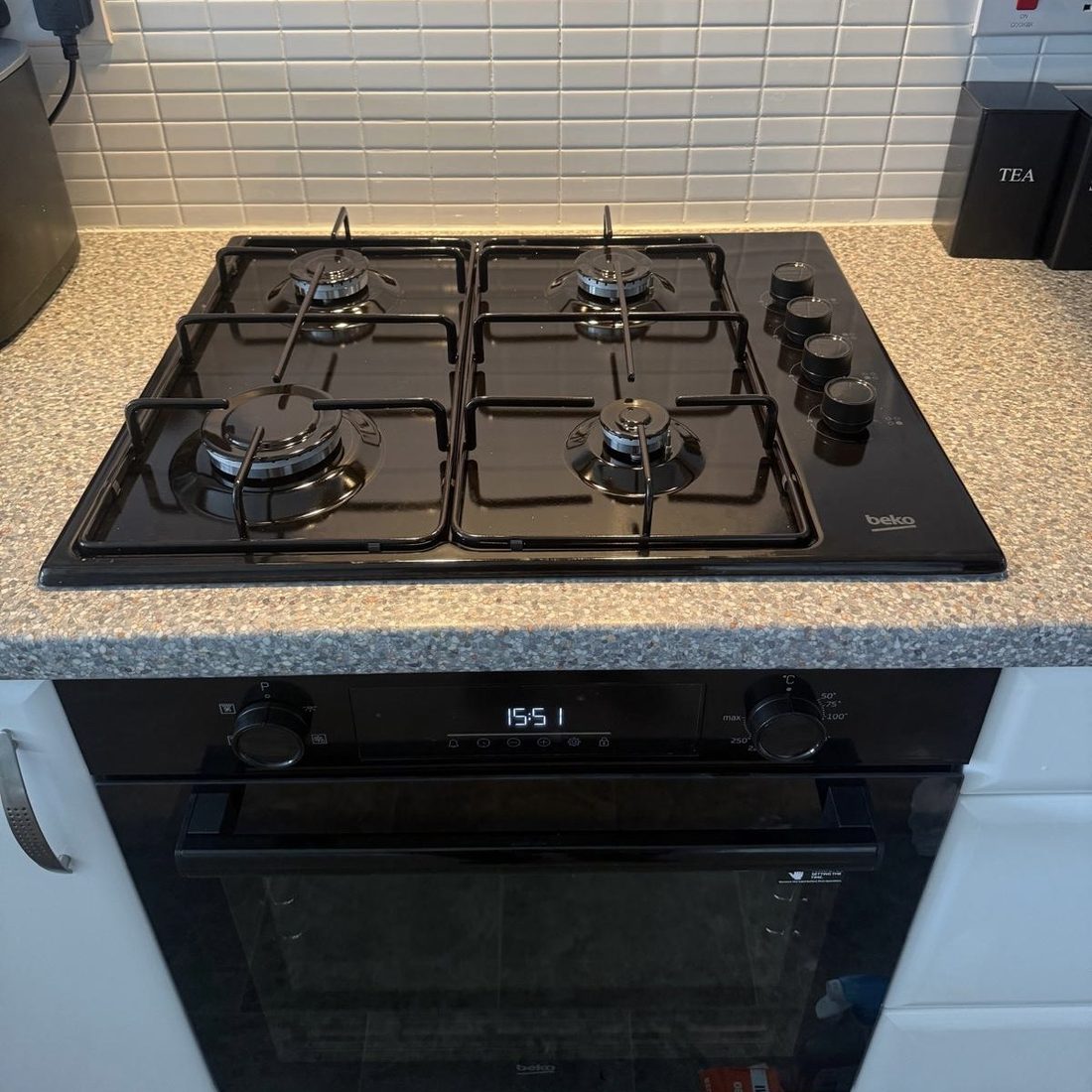 Gas hob and built-under oven installed in a fitted kitchen