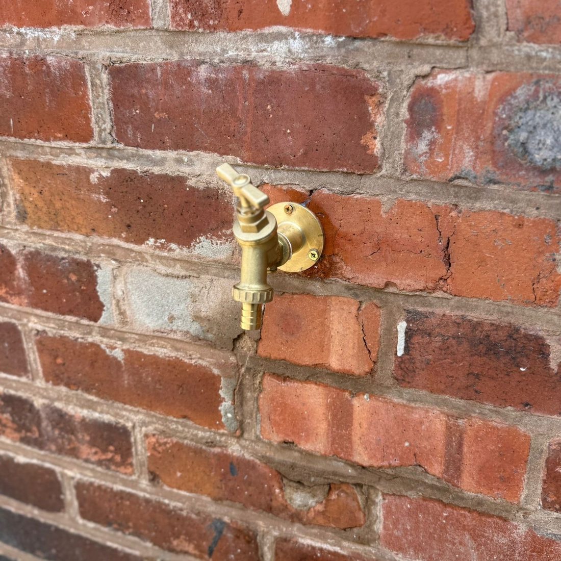 Brass outside tap fitted to an exterior wall