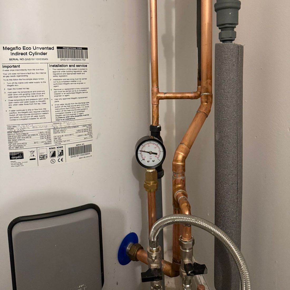 Unvented hot water cylinder with pressure gauge and valve set