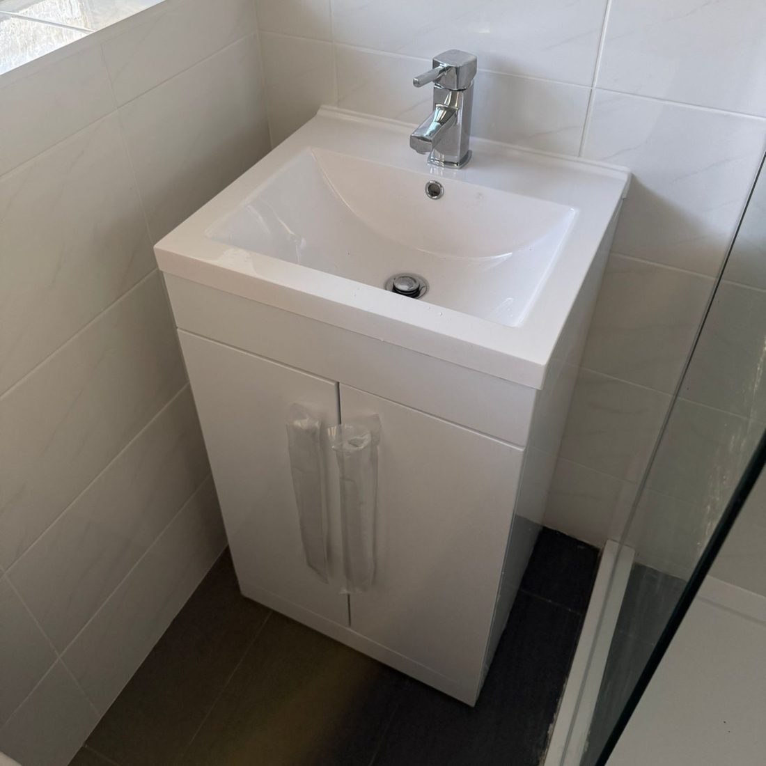 Vanity unit and basin installed in a tiled bathroom